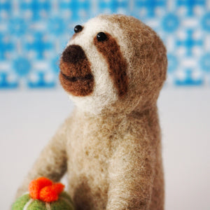 Needle felted sloth with blooming cactus plant