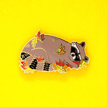 Load image into Gallery viewer, Sleeping raccoon in fall leaves enamel pin